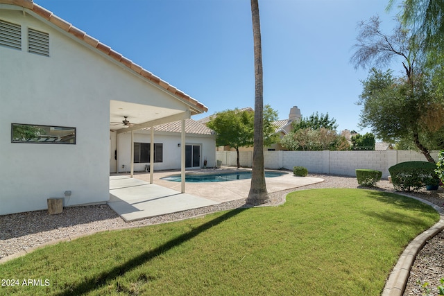 view of yard featuring a fenced in pool, a patio area, and ceiling fan