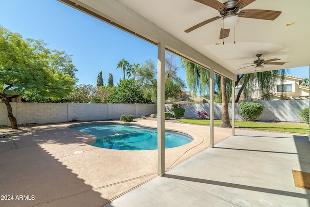 view of swimming pool with ceiling fan and a patio