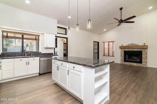 kitchen with a kitchen island, stainless steel dishwasher, dark hardwood / wood-style floors, and white cabinets