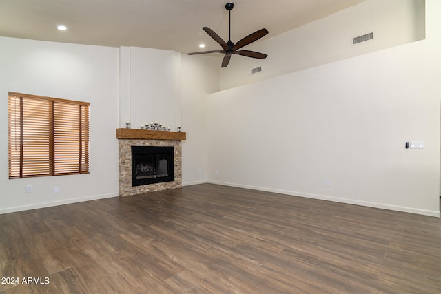 unfurnished living room with dark wood-type flooring, ceiling fan, and high vaulted ceiling