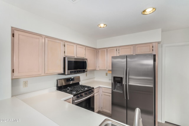 kitchen featuring light brown cabinets and appliances with stainless steel finishes