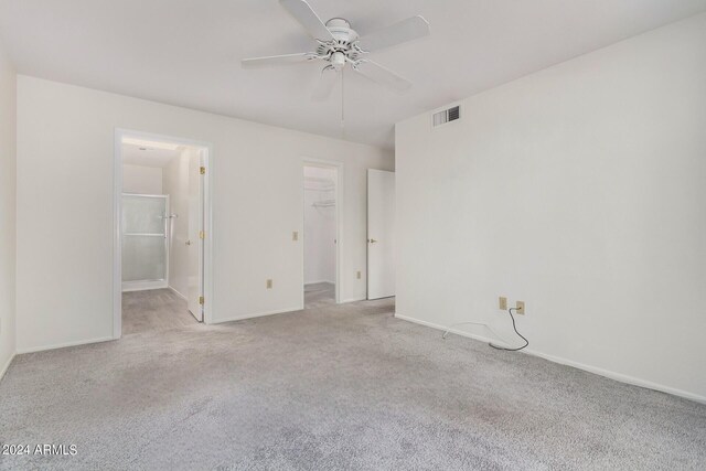 carpeted spare room with ceiling fan