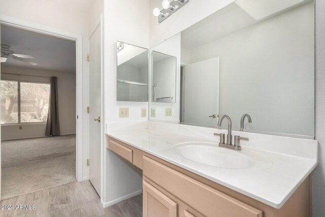 bathroom featuring ceiling fan, vanity, and hardwood / wood-style floors