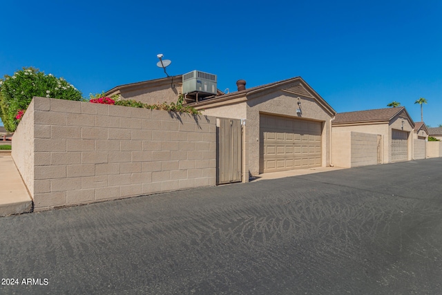 view of front of house featuring central AC and a garage