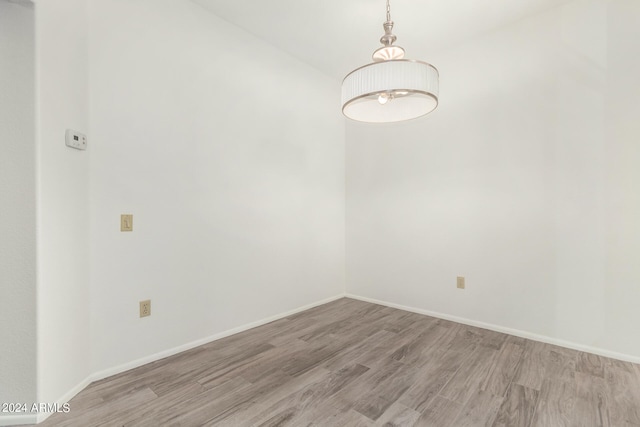 empty room with light hardwood / wood-style flooring