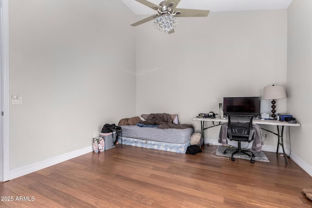 bedroom featuring wood finished floors, baseboards, a desk, and ceiling fan
