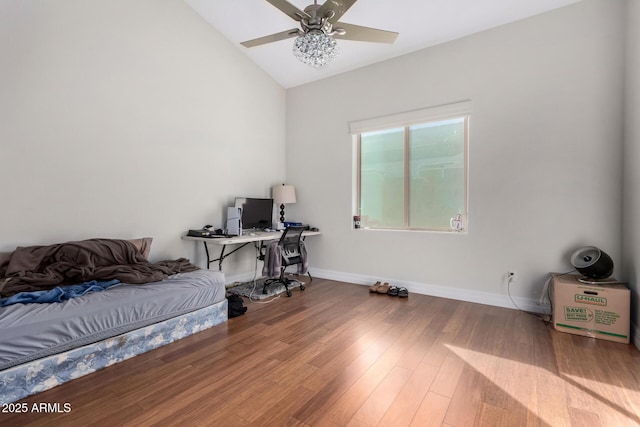 bedroom featuring vaulted ceiling, wood finished floors, baseboards, and ceiling fan