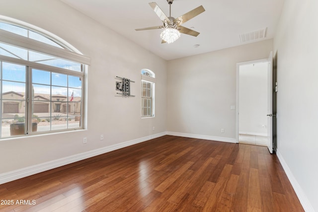 spare room featuring wood-type flooring, baseboards, and a ceiling fan