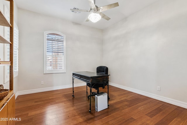 office featuring hardwood / wood-style flooring, a ceiling fan, and baseboards