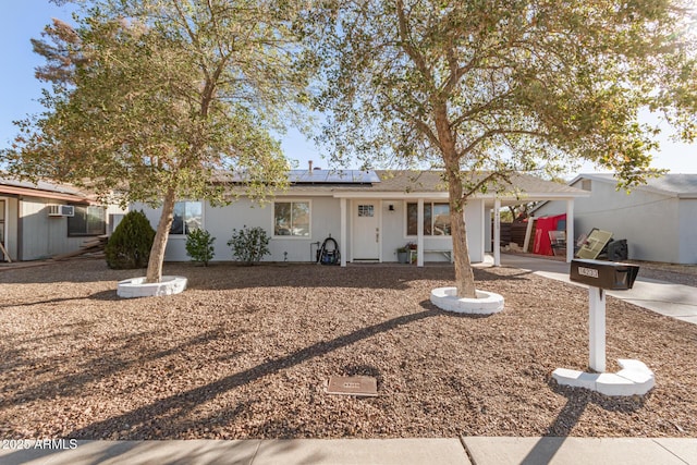 single story home featuring solar panels