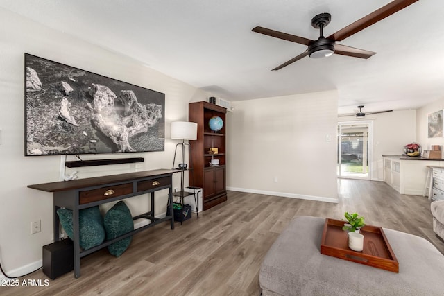 living room with ceiling fan and light hardwood / wood-style floors