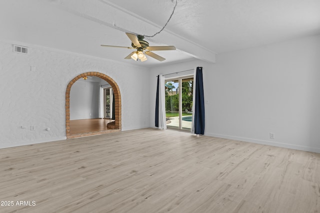 2916 S Revere Cir, Mesa, AZ 85210 - unfurnished room featuring wood finished floors, arched walkways, beam ceiling, a ceiling fan, and baseboards