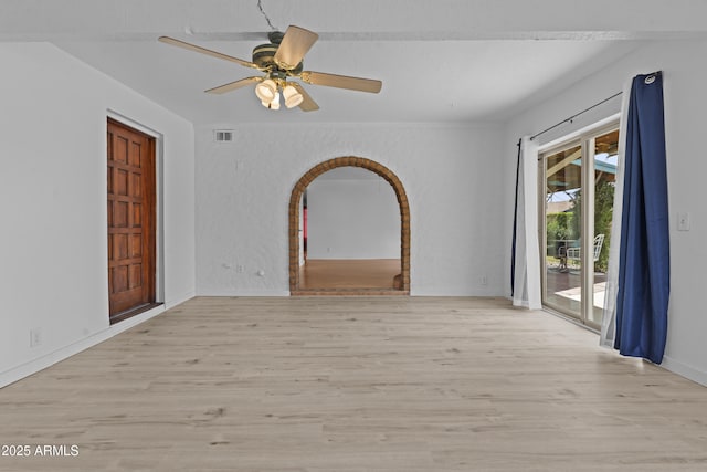 2916 S Revere Cir, Mesa, AZ 85210 - unfurnished room with wood finished floors, a ceiling fan, arched walkways, and baseboards