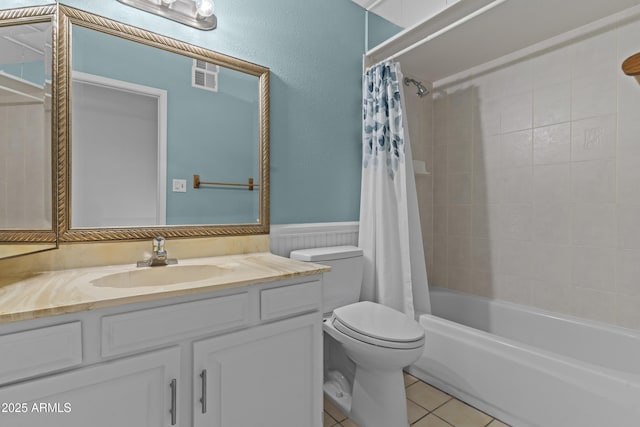 2916 S Revere Cir, Mesa, AZ 85210 - bathroom featuring toilet, vanity, tile patterned floors, shower / tub combo with curtain, and a wainscoted wall