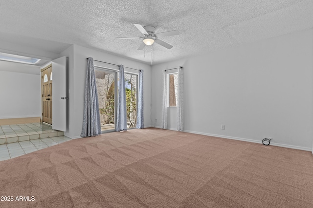 2916 S Revere Cir, Mesa, AZ 85210 - unfurnished room featuring carpet flooring, a ceiling fan, a textured ceiling, baseboards, and tile patterned floors