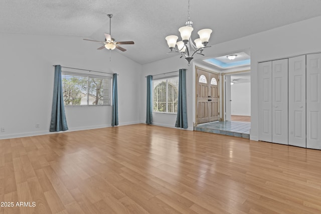 2916 S Revere Cir, Mesa, AZ 85210 - unfurnished living room with a chandelier, a ceiling fan, light wood-style flooring, lofted ceiling, and a textured ceiling