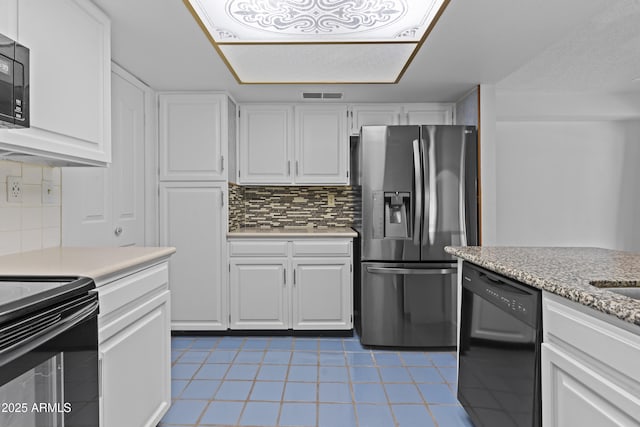 2916 S Revere Cir, Mesa, AZ 85210 - kitchen with black appliances, light tile patterned floors, white cabinets, and decorative backsplash