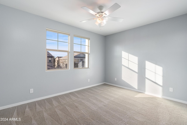 unfurnished room with light carpet and ceiling fan