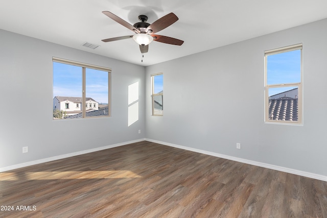 spare room with ceiling fan and dark hardwood / wood-style flooring