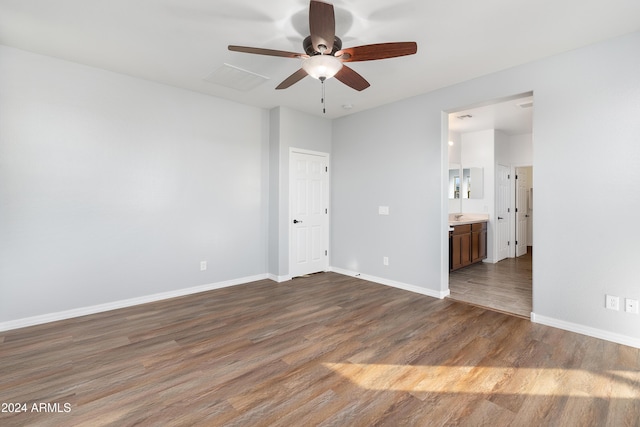 spare room with hardwood / wood-style floors and ceiling fan