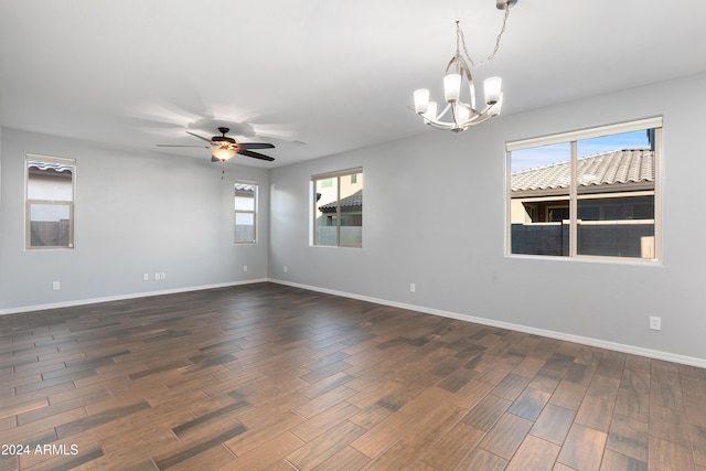 unfurnished room featuring ceiling fan with notable chandelier