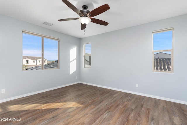 unfurnished room featuring ceiling fan and dark hardwood / wood-style flooring