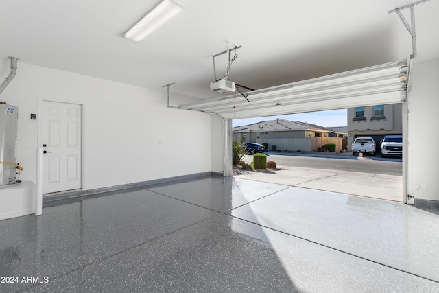 garage with a garage door opener and water heater