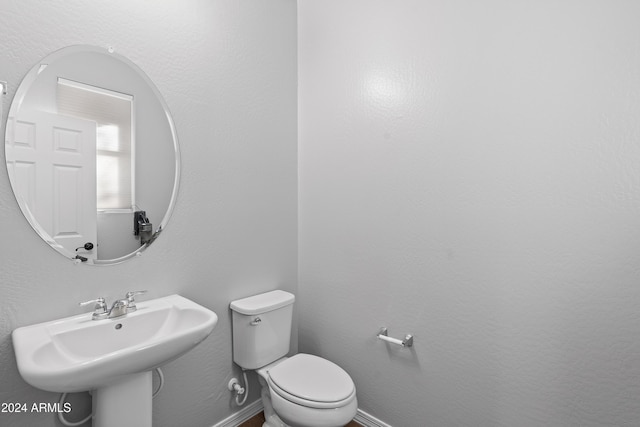 bathroom with toilet and sink