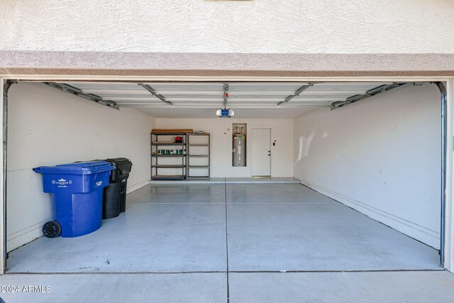 garage with a garage door opener and electric water heater