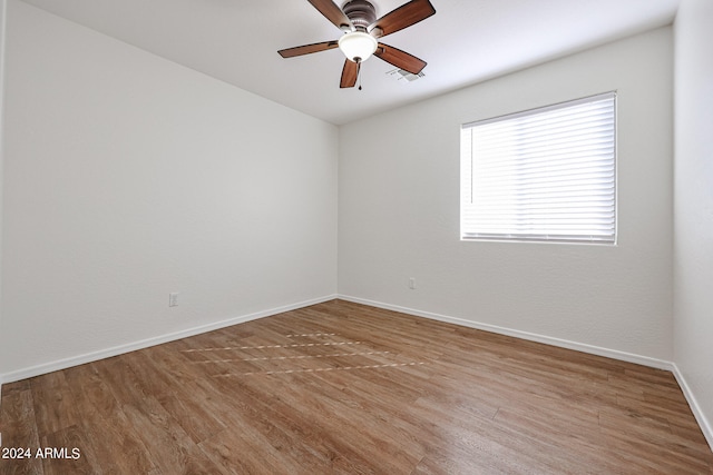 spare room with hardwood / wood-style flooring and ceiling fan