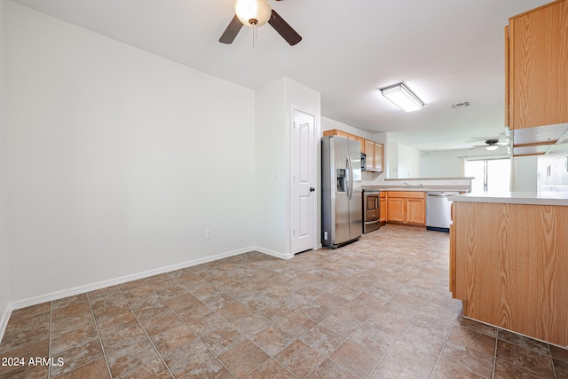 kitchen with appliances with stainless steel finishes, ceiling fan, and sink