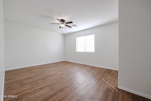 unfurnished room with ceiling fan and hardwood / wood-style flooring