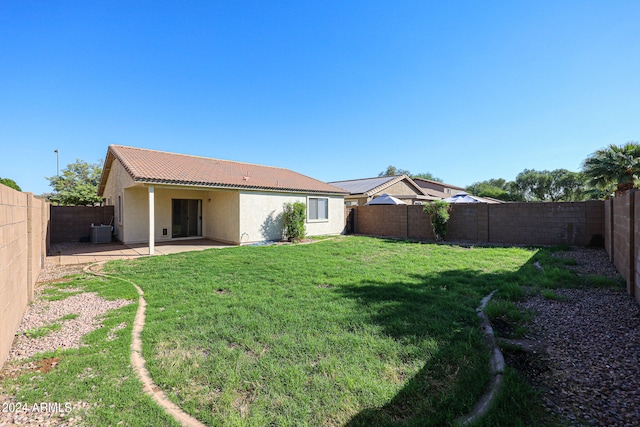 view of yard featuring central AC unit and a patio