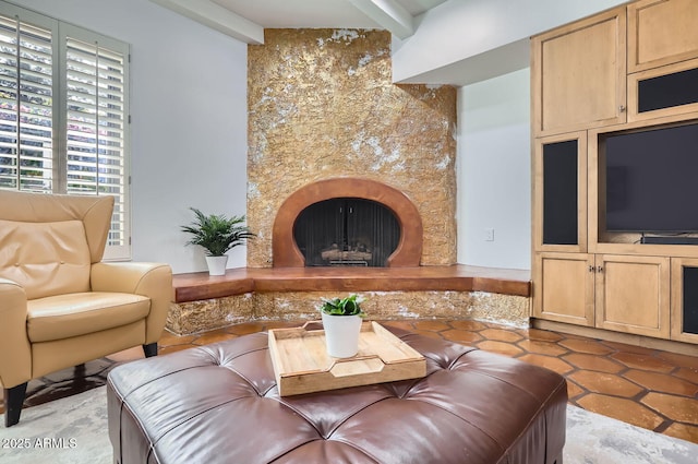 tiled living room with a premium fireplace and beamed ceiling