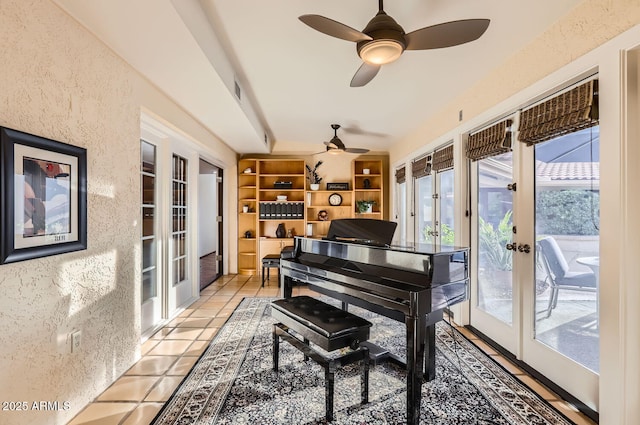 miscellaneous room with light tile patterned floors, built in shelves, french doors, and ceiling fan