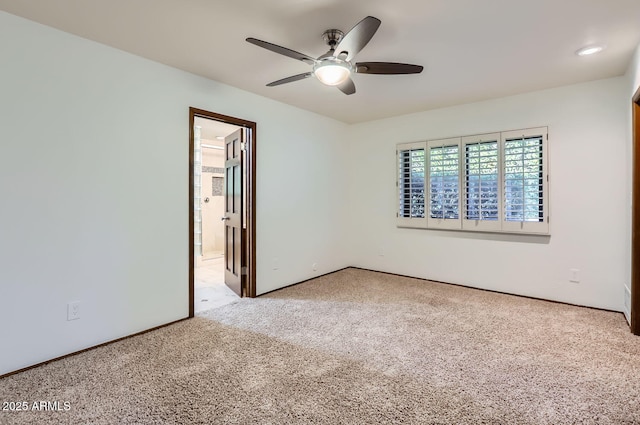 empty room with light colored carpet and ceiling fan