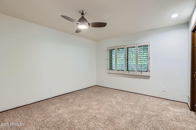 empty room with carpet flooring and ceiling fan