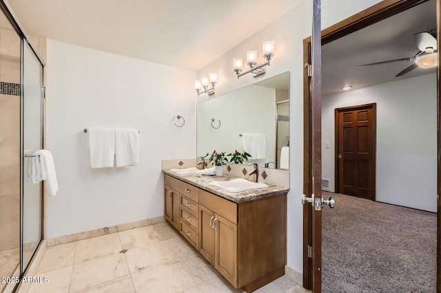 bathroom featuring ceiling fan, vanity, and a shower with shower door