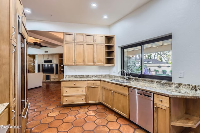 kitchen featuring light brown cabinetry, dishwasher, sink, ceiling fan, and light stone counters