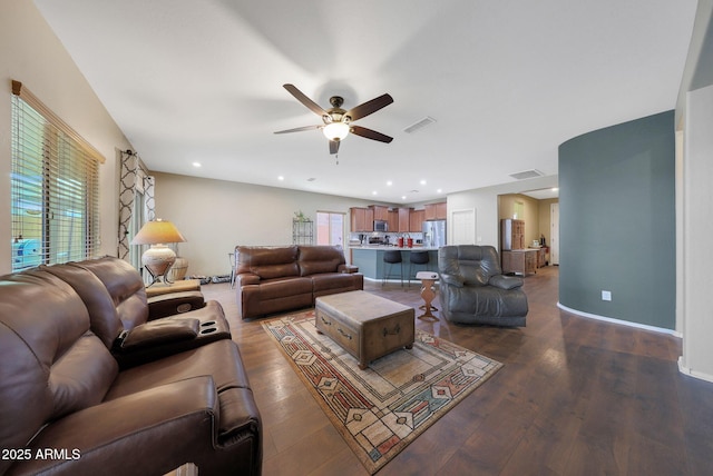 living room featuring hardwood / wood-style flooring and ceiling fan