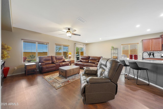 living room with ceiling fan, sink, and dark hardwood / wood-style flooring