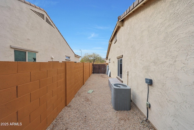 view of side of home with central AC