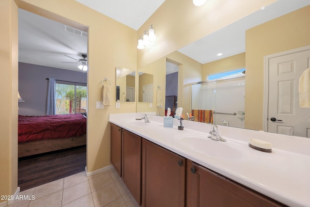 bathroom featuring ceiling fan, tile patterned floors, an enclosed shower, and vanity