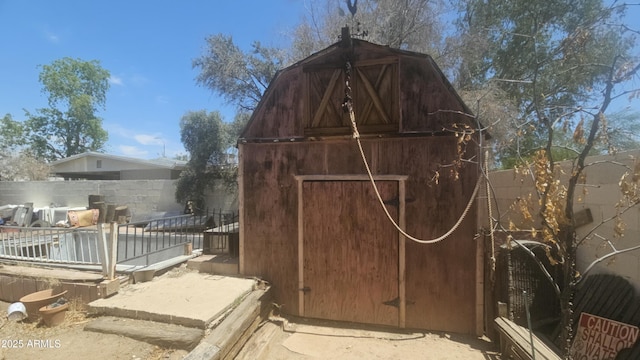view of barn with fence