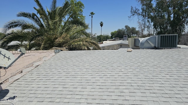 exterior details featuring roof with shingles
