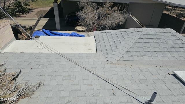 exterior details featuring a shingled roof