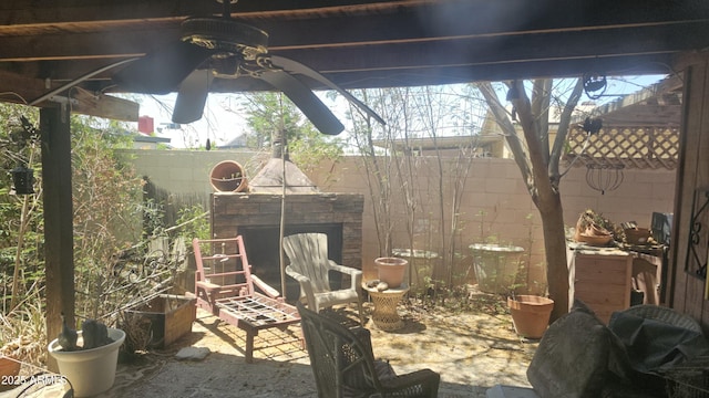 view of patio / terrace with a fenced backyard and exterior fireplace