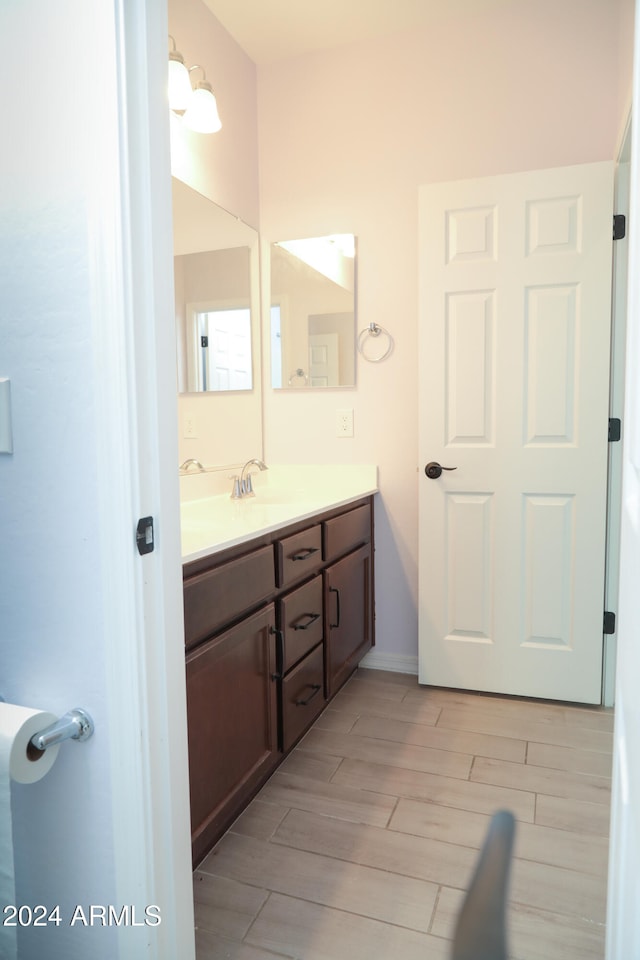 bathroom with vanity and hardwood / wood-style flooring