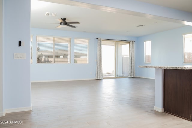 unfurnished living room featuring light hardwood / wood-style flooring and ceiling fan