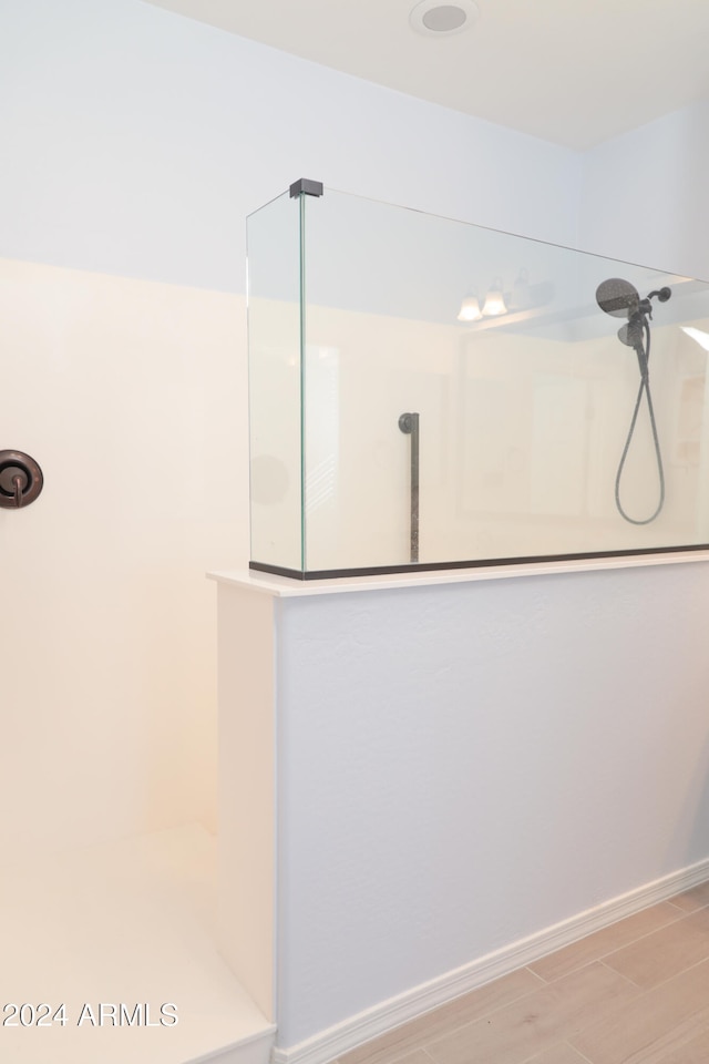 bathroom featuring a shower and wood-type flooring